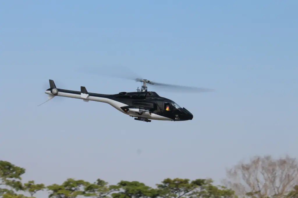 Flish RC Airwolf 450 scale RC helicopter in flight against a blue sky